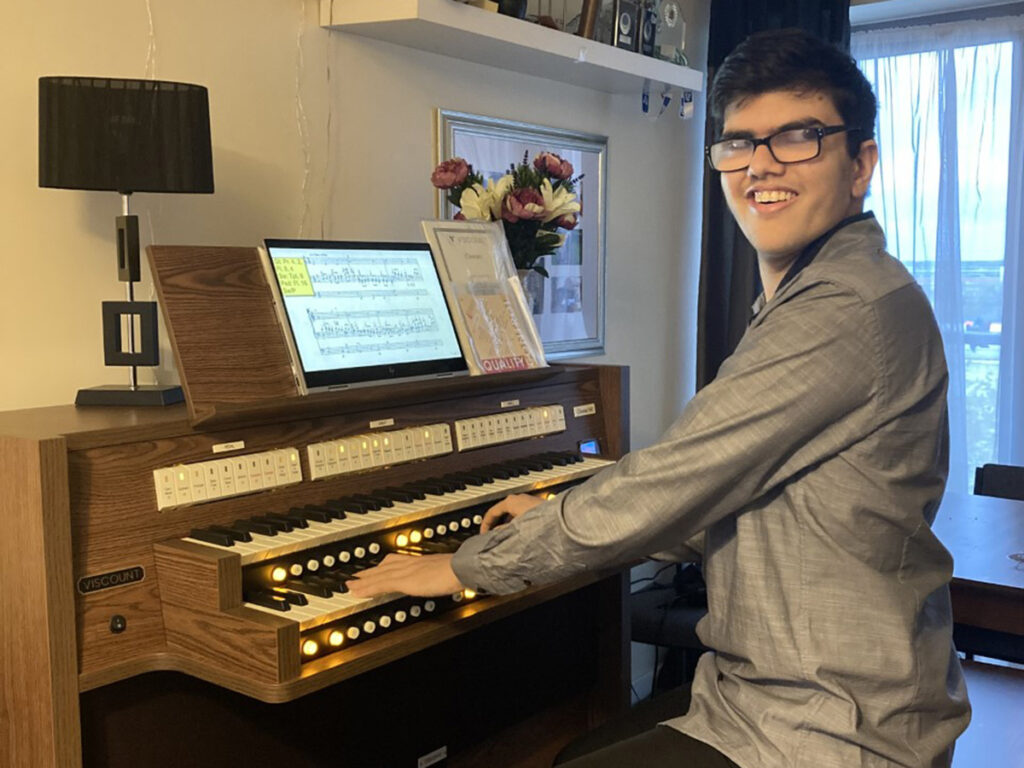 Sixteen-year-old Ivan Deb, the 2021 winner of the Trust's Aprahamian Scholarship for visually impaired organists. He is playing the home practice-organ provided by the Trust in partnership with Viscount Classical Organs.
